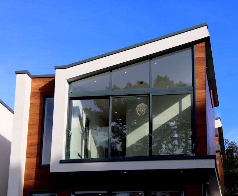 Contemporary house in Poole, UK featuring a sleek design with large glass windows and wood paneling