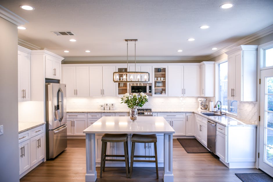 Spacious and elegant kitchen featuring white cabinetry